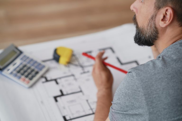 Man leaning over real estate projects